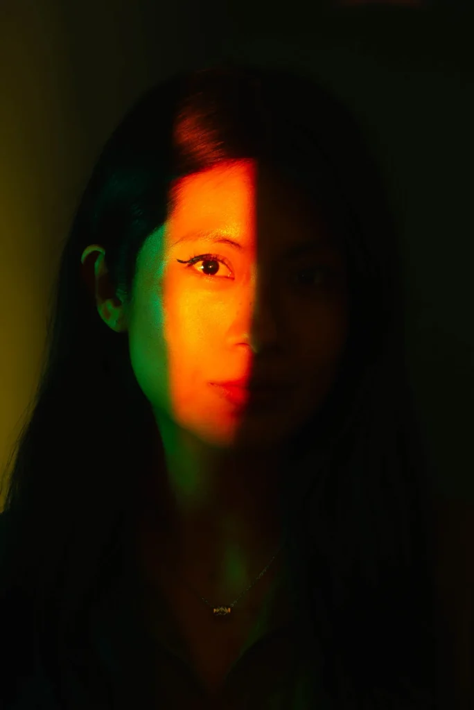 The light splits her face in two