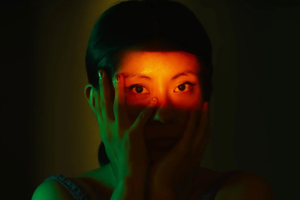 Hands over the face; only the eyes