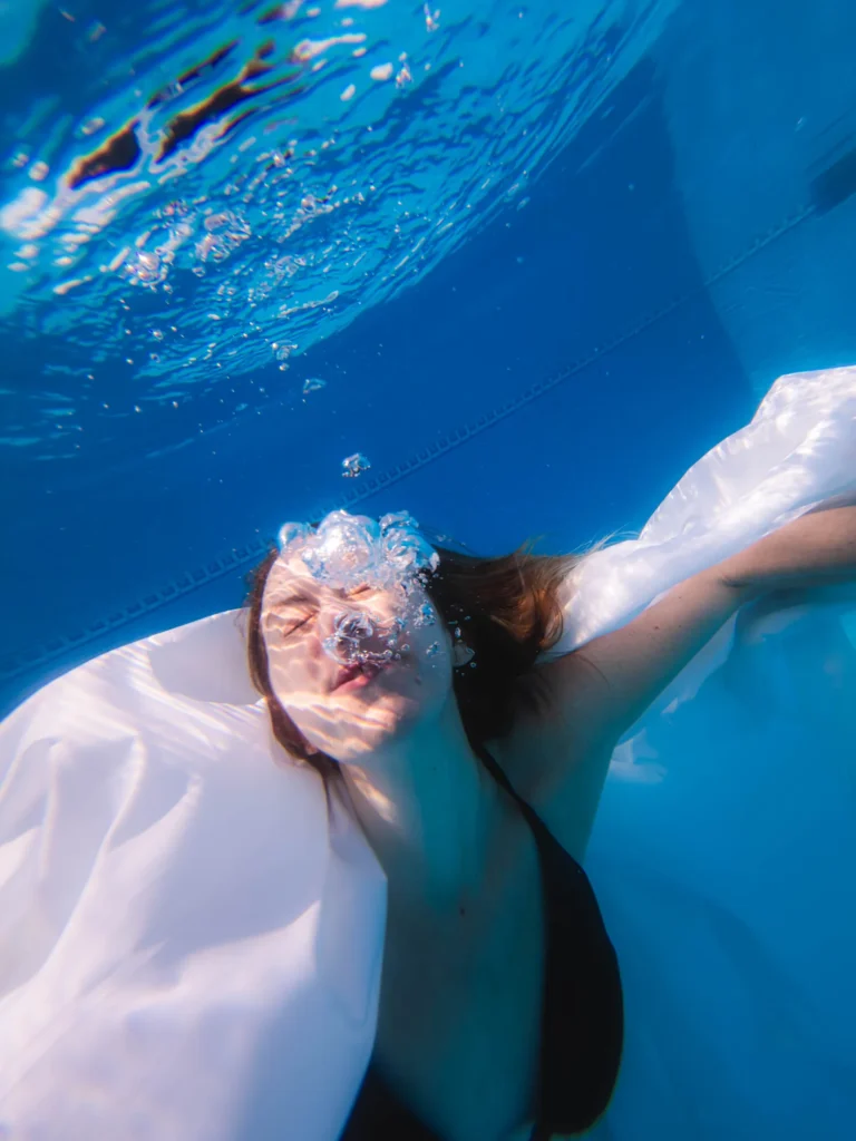 Bubbles over her face, white fabric