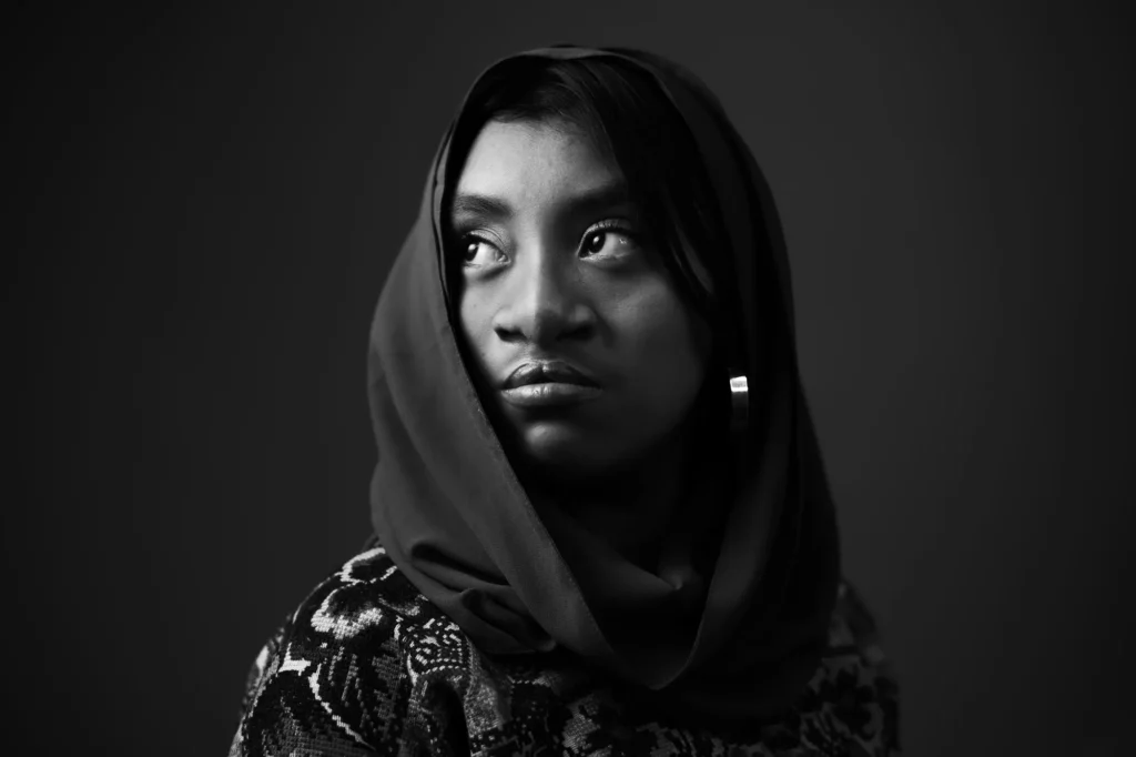 A hood and a steady gaze, in black and white
