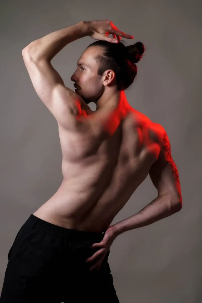 Back turned, an arm over his head