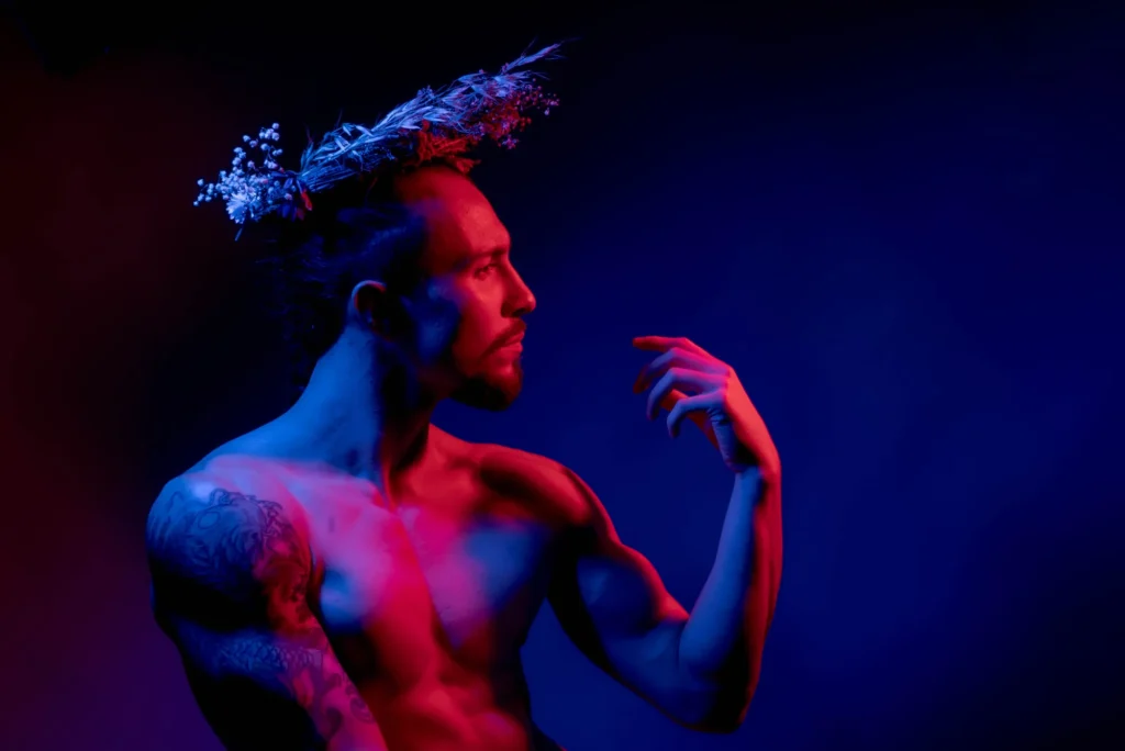 Crowned, a hand reaching out, in red and blue