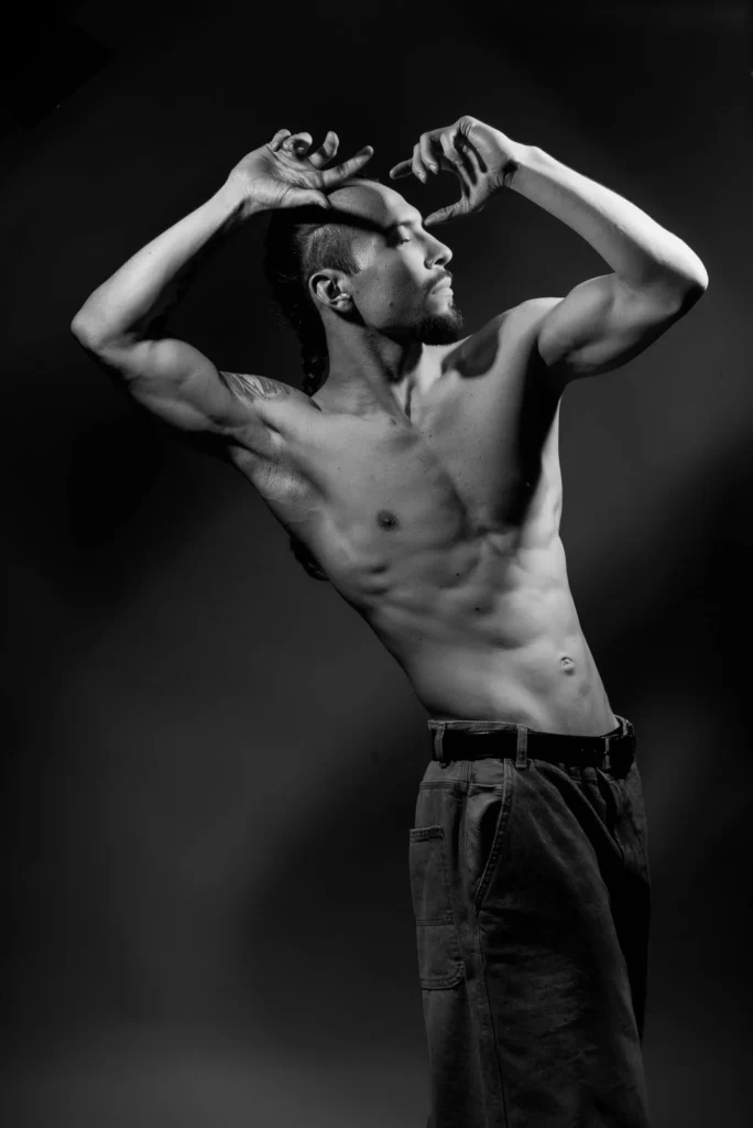Arms framing his head, in black and white