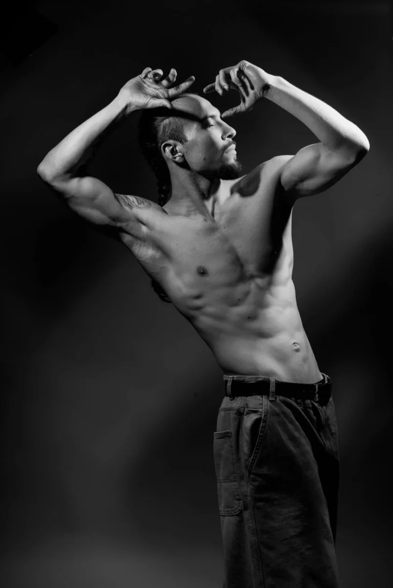Arms framing his head, in black and white