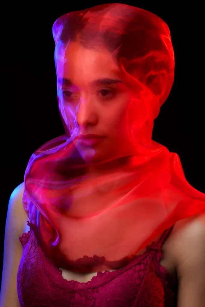 Red organza over her face