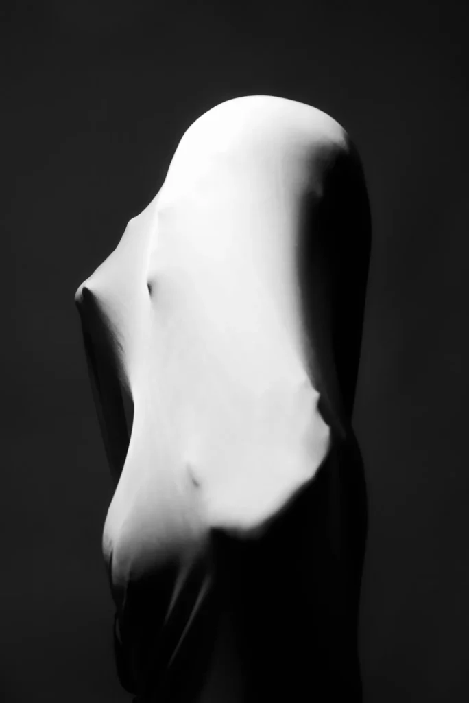 The covered figure, in black and white