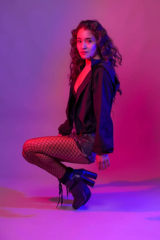 Crouched in magenta light