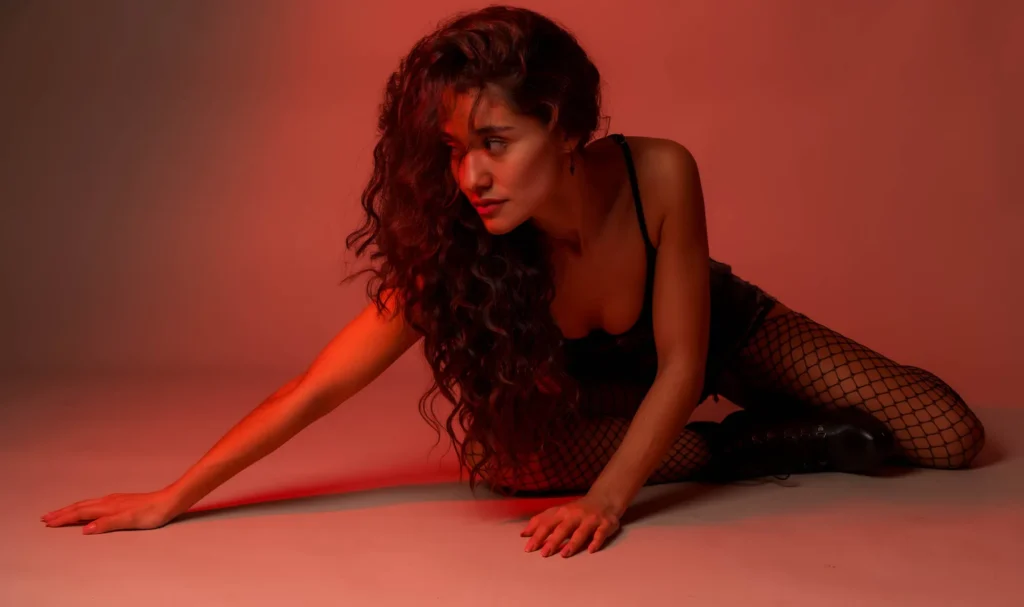 Stretched on the floor, in orange light