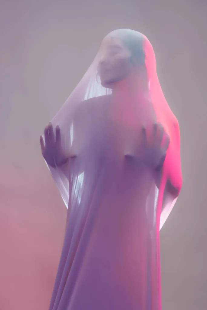 Pressing against a veil of fabric