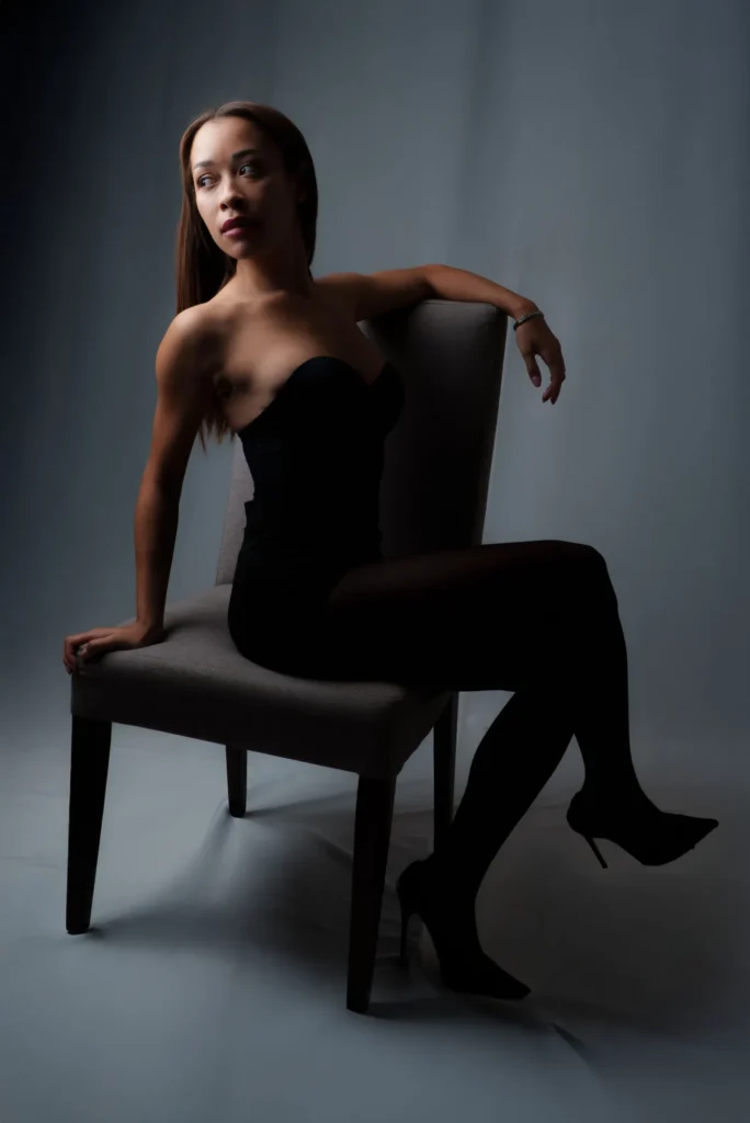 Seated sideways on the chair
