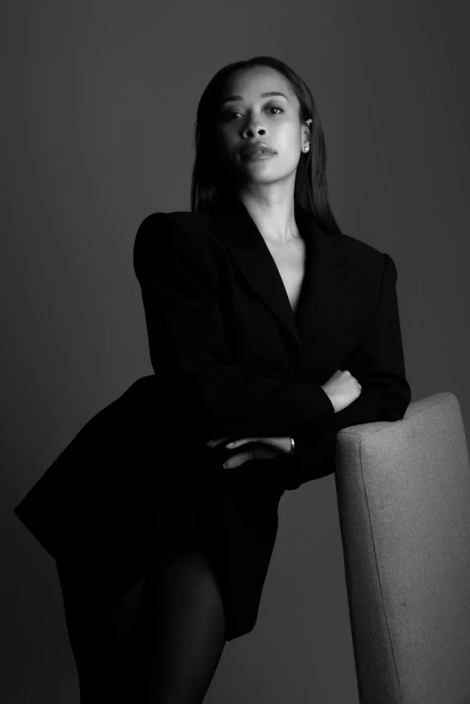A black blazer against a chair, in black and white
