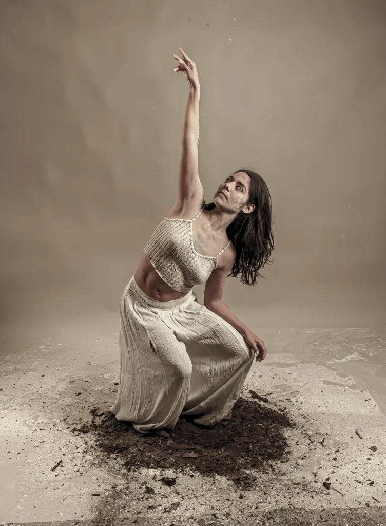 An arm raised over a circle of earth