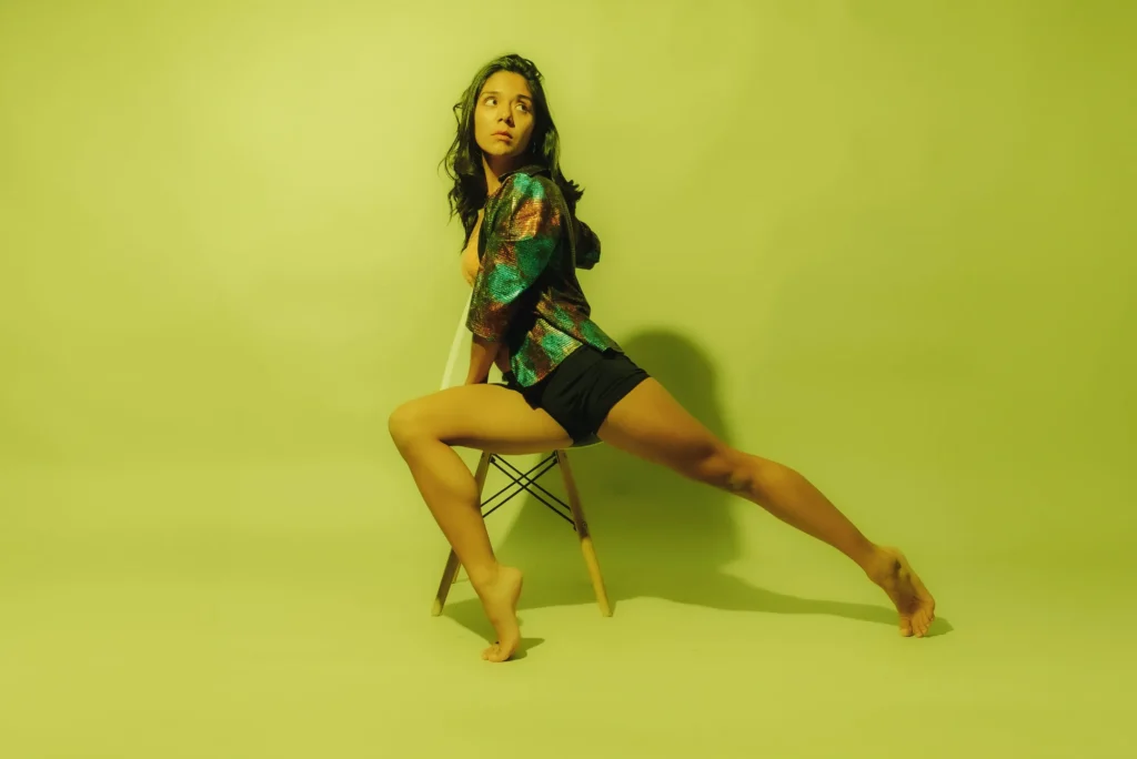 On a chair against yellow