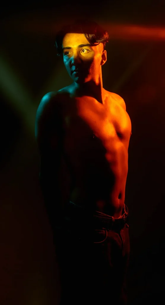 Orange light and a band of shadow across the eyes