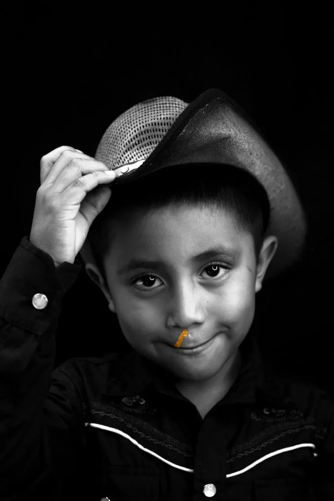 A boy tips his hat