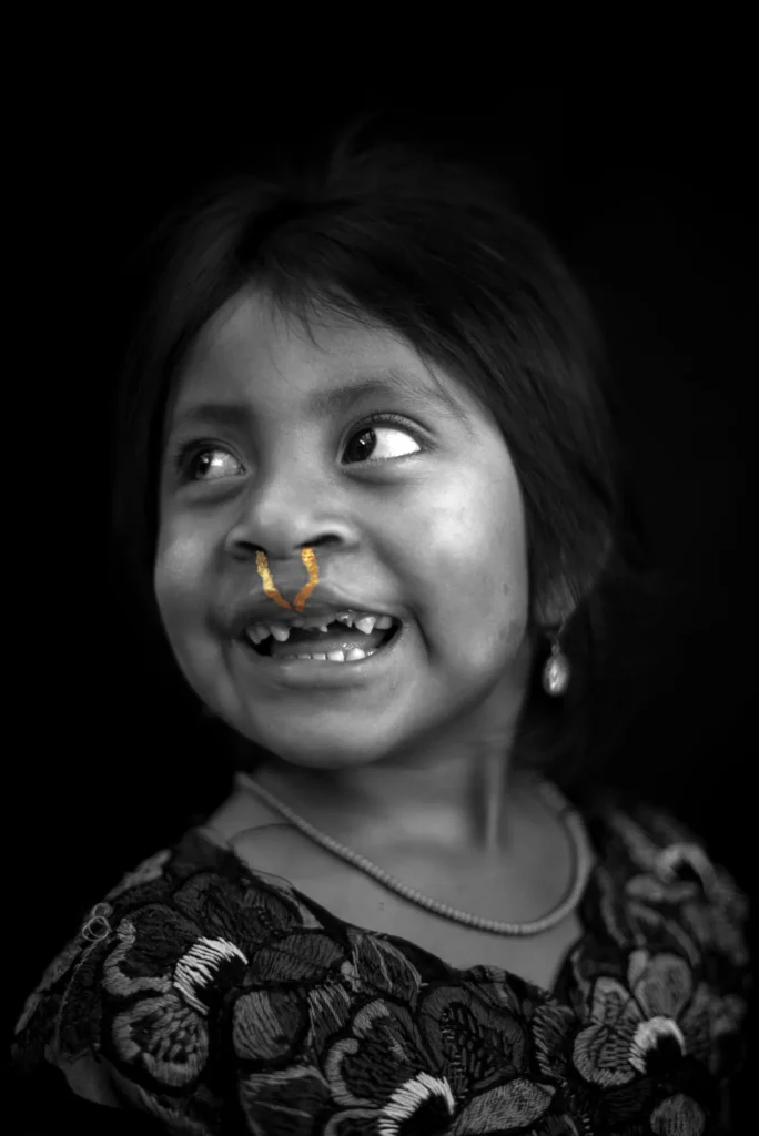 The same girl looks away, the gold on her lip