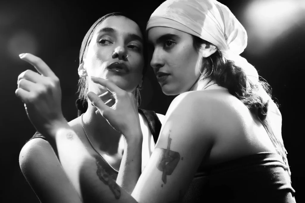 Faces together in hard light, in black and white
