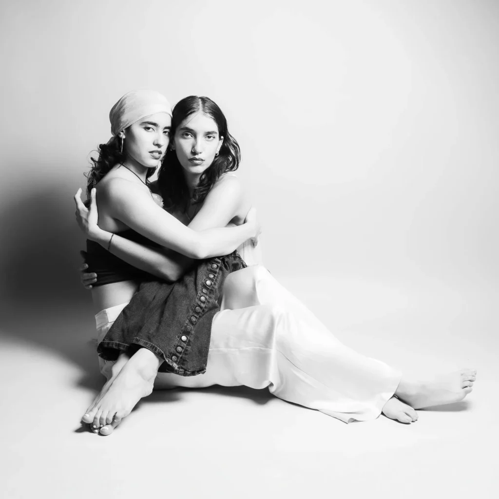 Seated in an embrace, in black and white