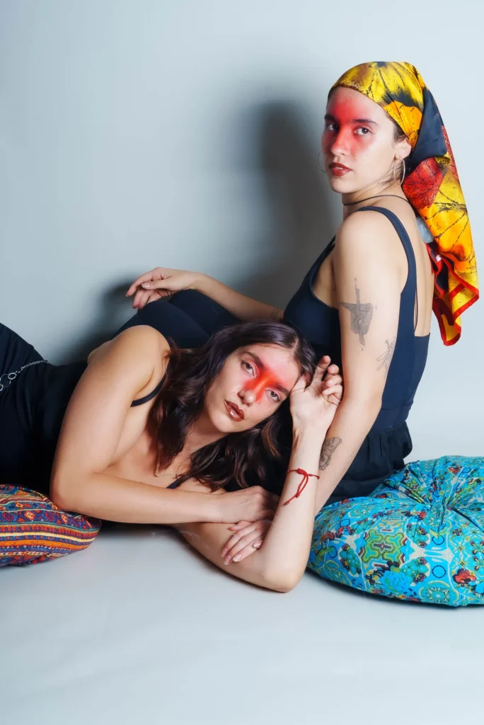 Red paint across their eyes, on the cushions