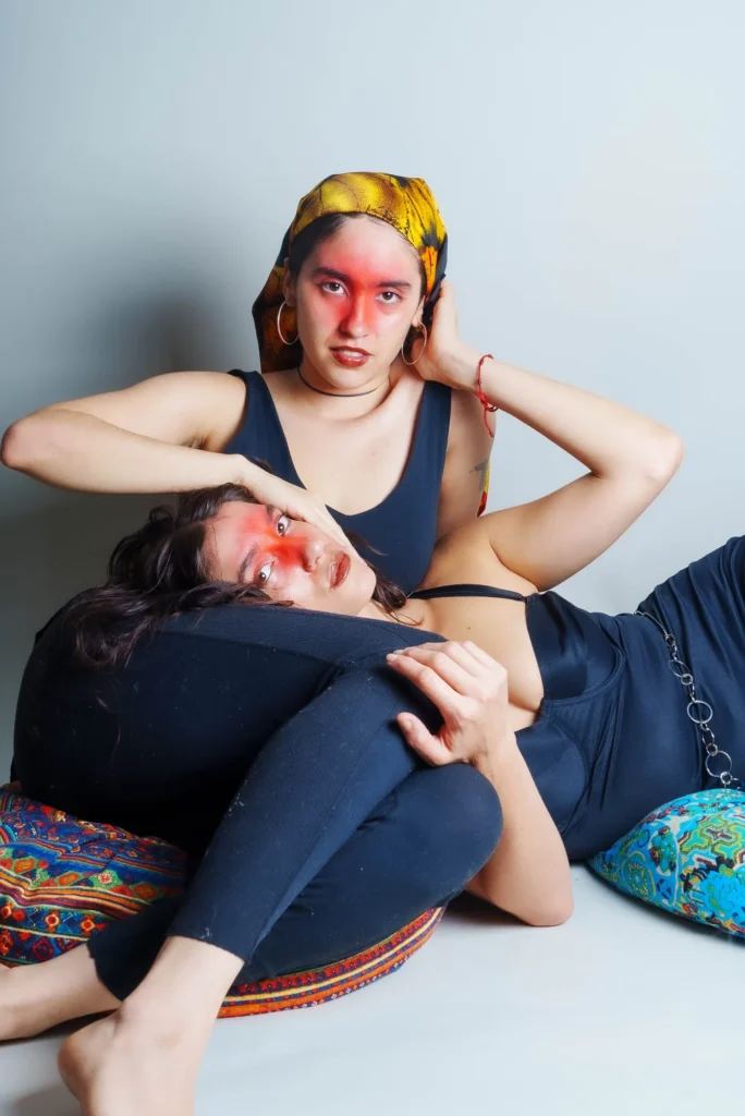 Red paint and yellow scarves, one resting on the other
