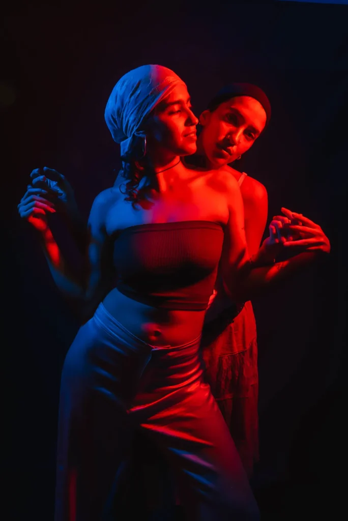 One behind the other, in red and blue light
