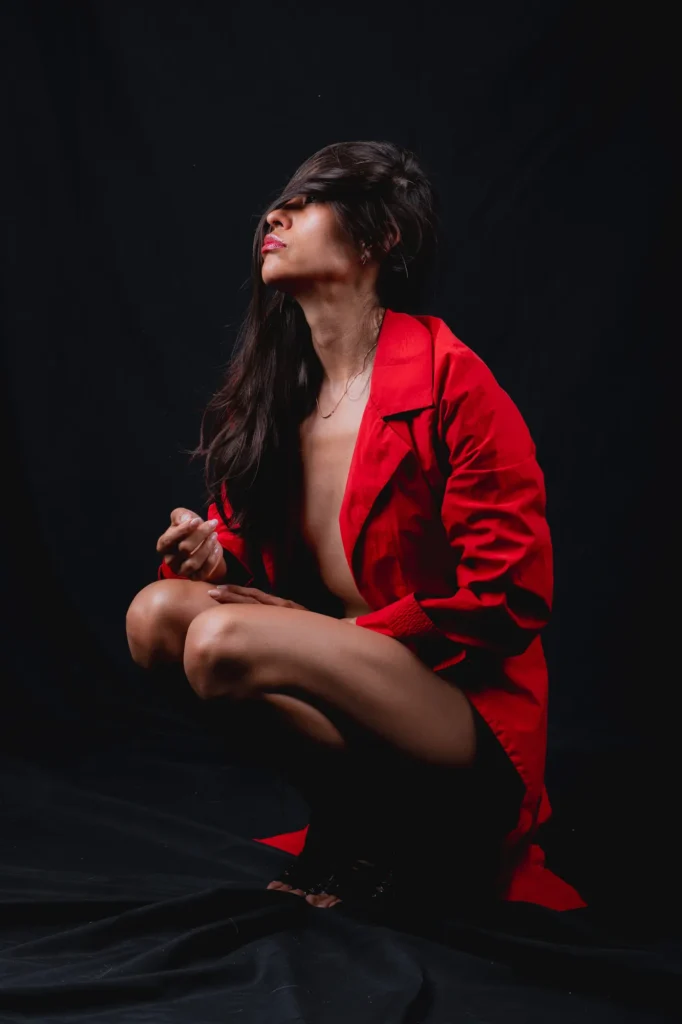 Crouched in the red coat