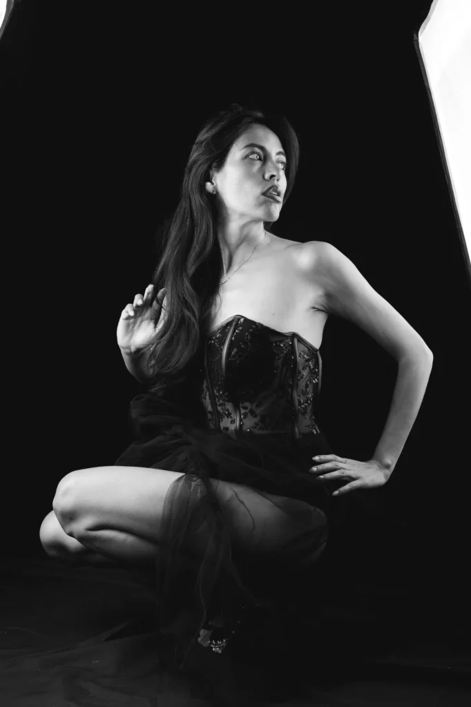 Kneeling in a corset, in black and white