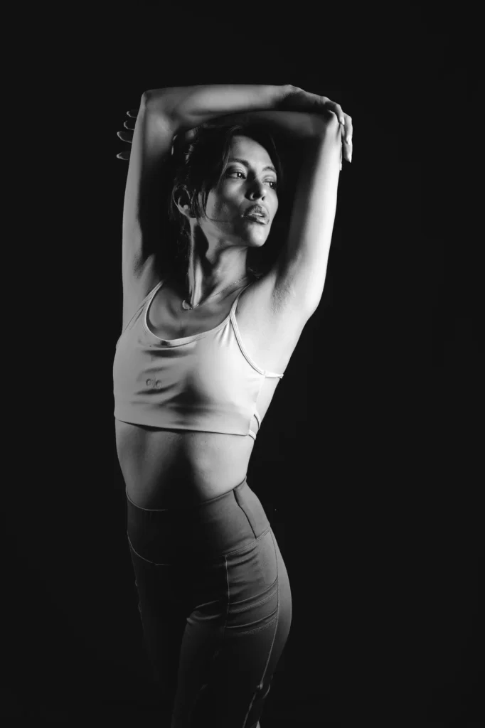 Arms overhead, in black and white