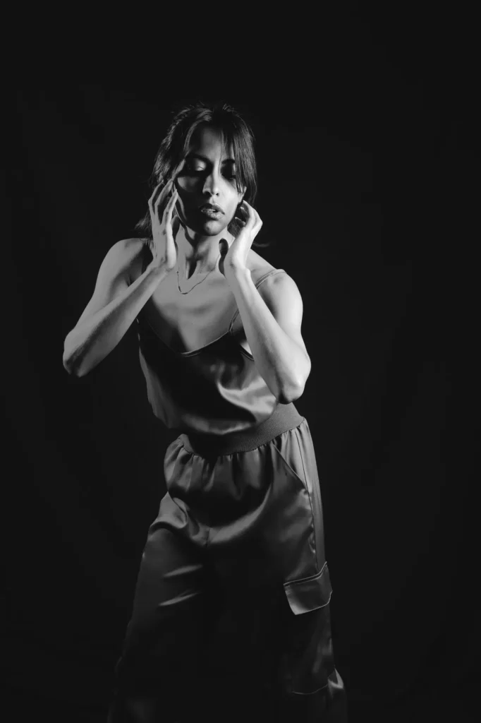 Hands at her face, in black and white