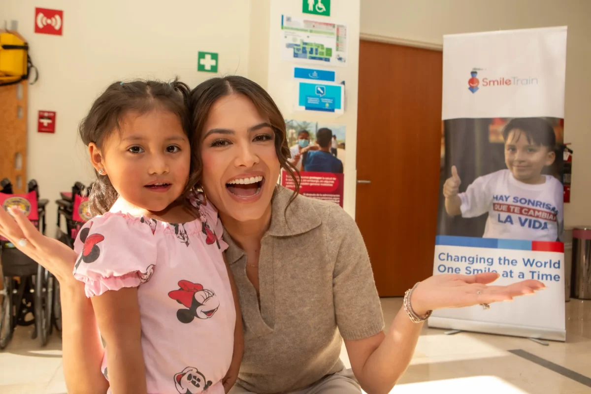 Andrea Meza celebrates with a girl at the clinic