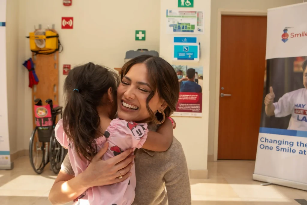 Andrea Meza hugs a girl