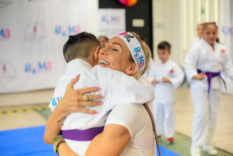 Charlotte hugs a taekwondo student