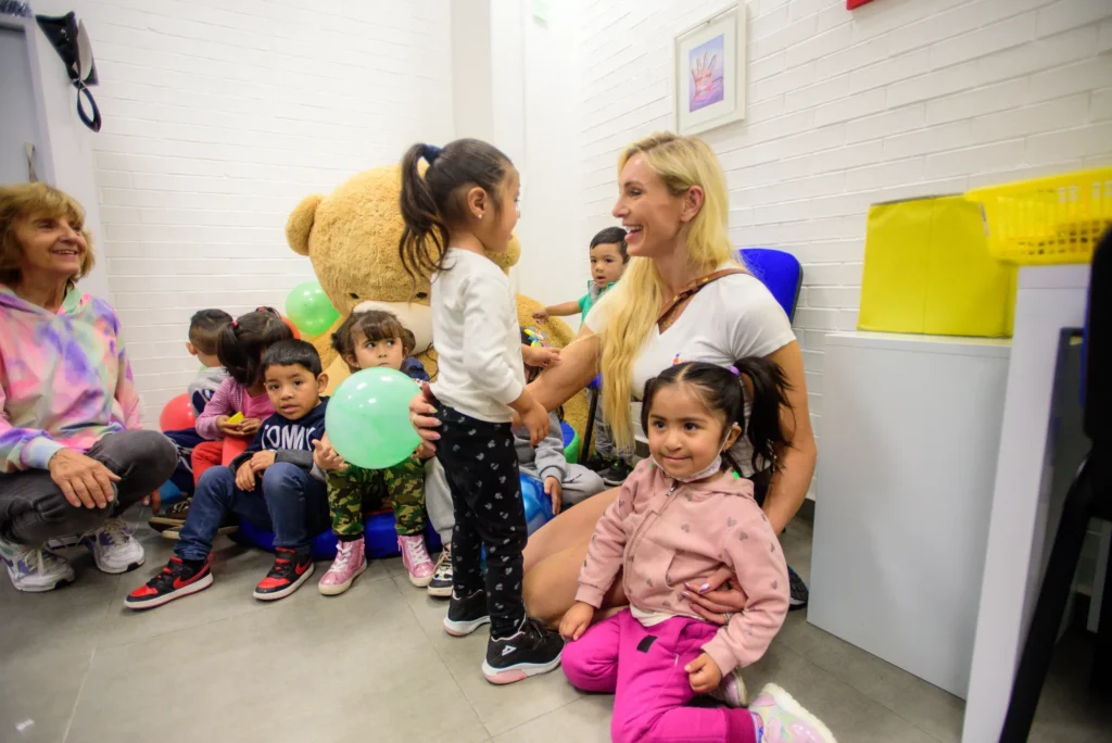 Charlotte with children in the waiting room