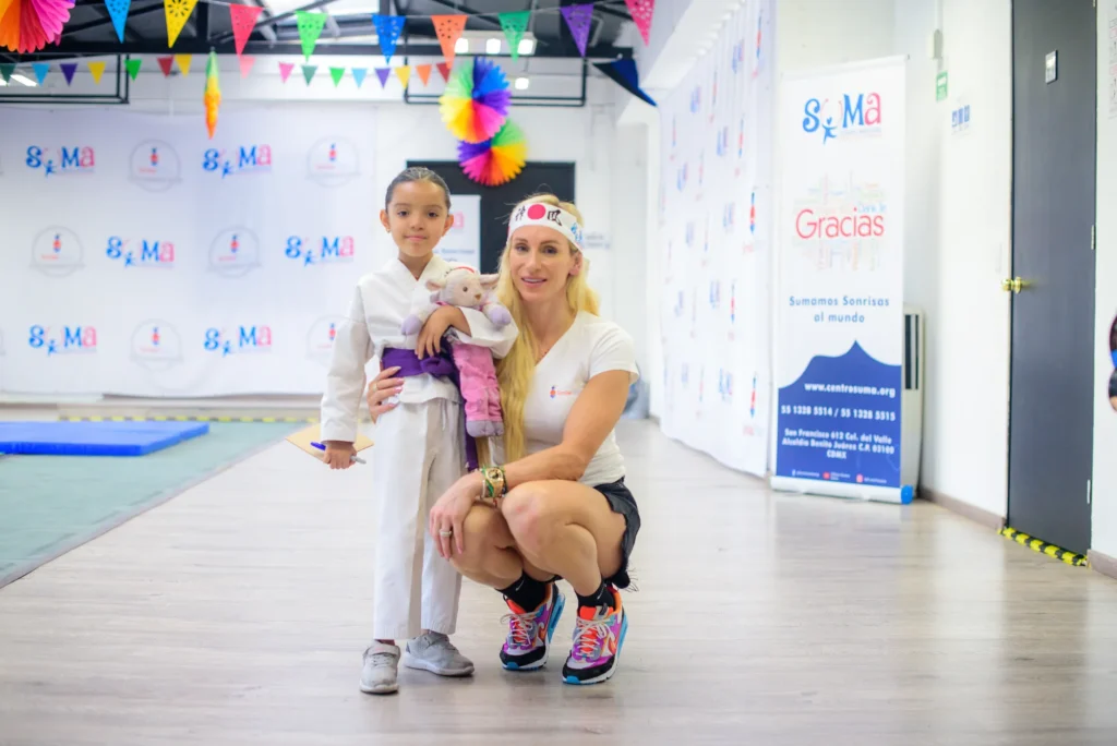 Charlotte with a girl by a thank-you banner