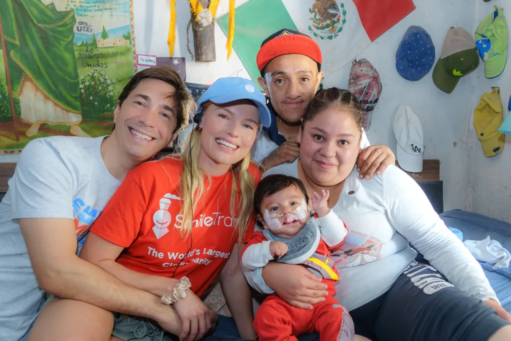 Kate and Justin with a family at home, among Mexican flags