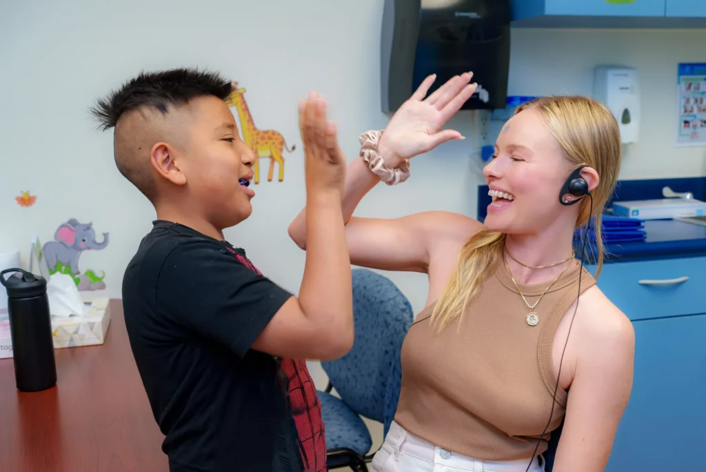 Kate high-fives a boy