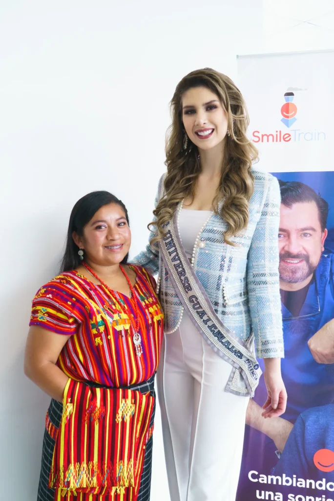 Miss Universe Guatemala with a woman in traditional dress