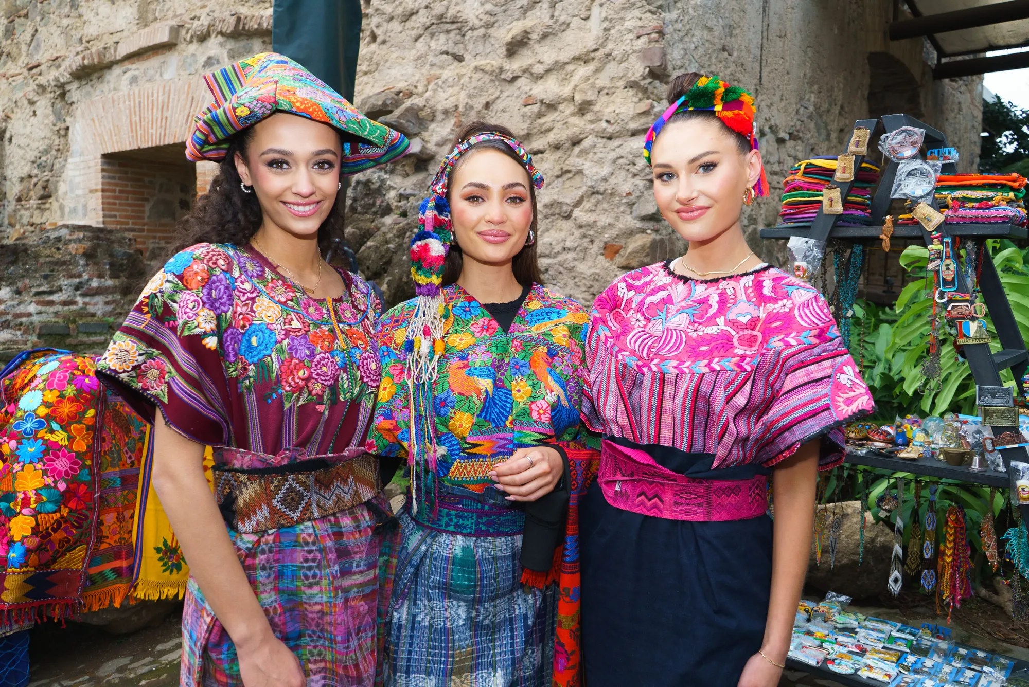 Three titleholders in traditional dress