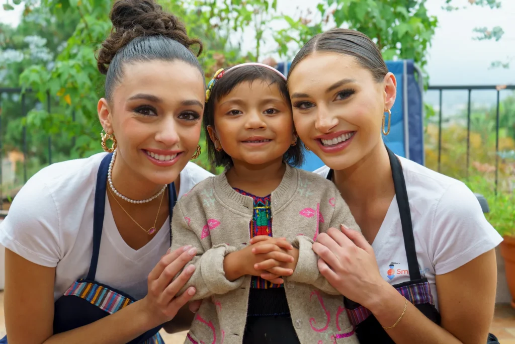 Three titleholders with two little girls
