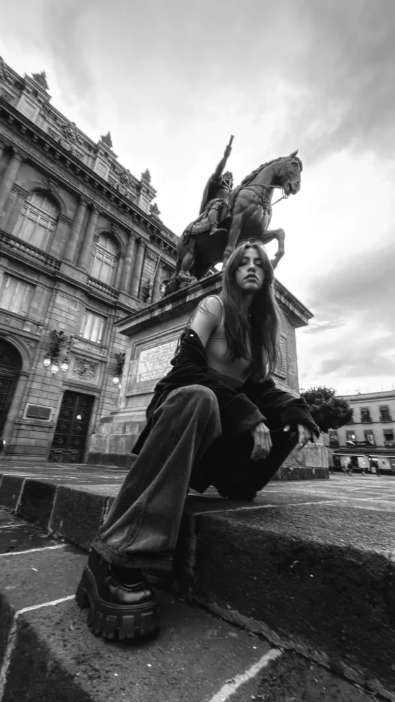 At the foot of the equestrian statue, in black and white