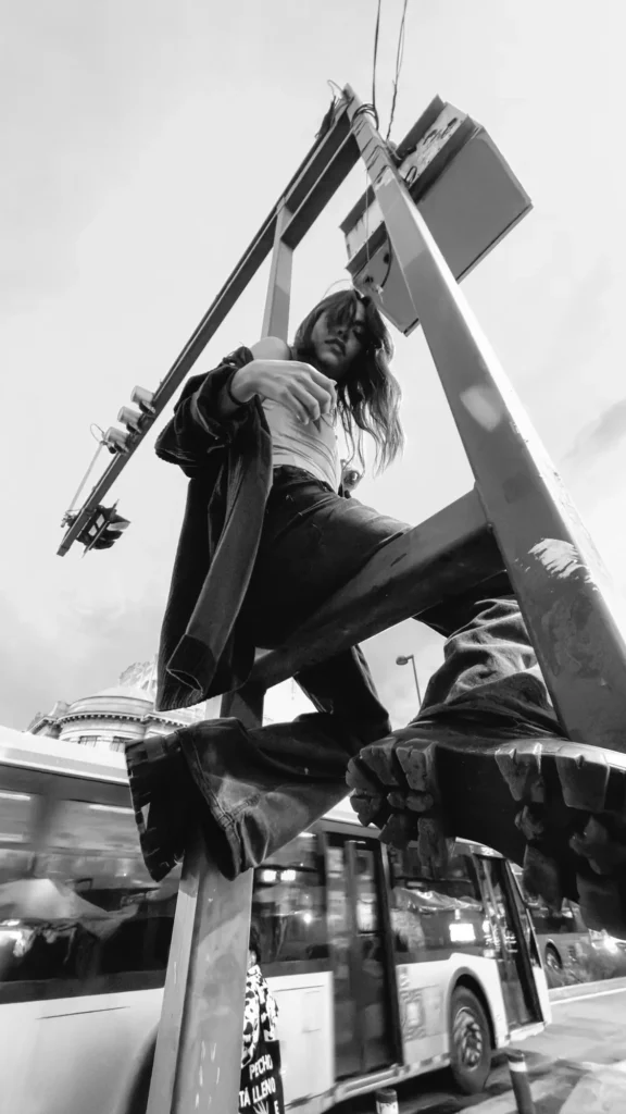 Climbing a street sign, a bus below