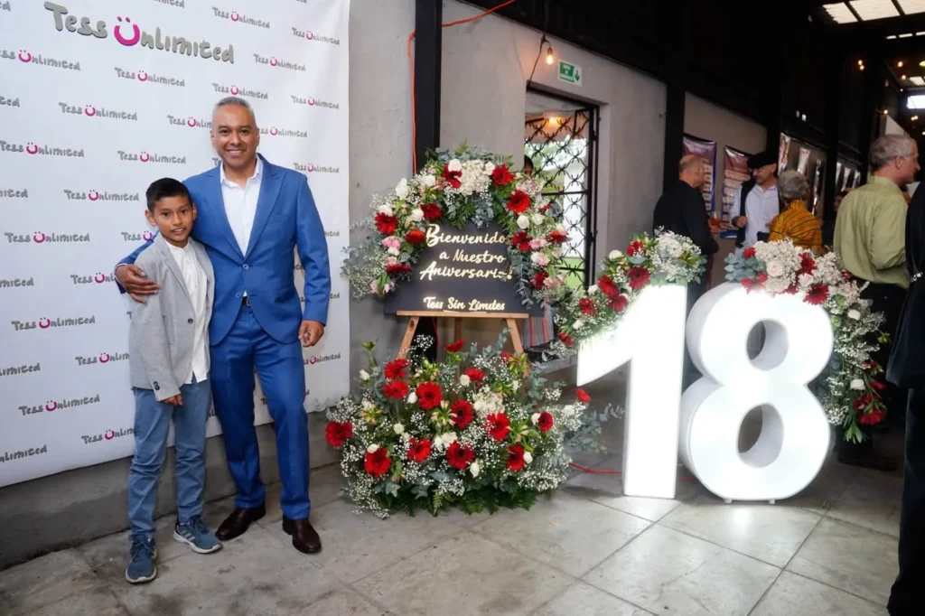 A boy and his father by the 18th anniversary flowers